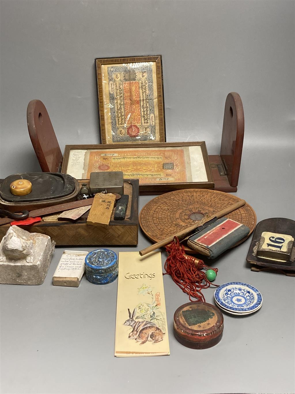 A group of Chinese and Japanese objects, 19th/20th century, including an inscribed ink box an inkstone, a lacquer bookslide, two Tibeta